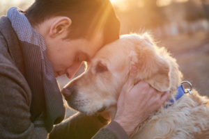 Man embracing his faithful friend the dog